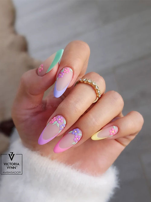 Long almond-shaped matte pastel multi-color French nails adorned with flowers are one of the best spring nail ideas 2024