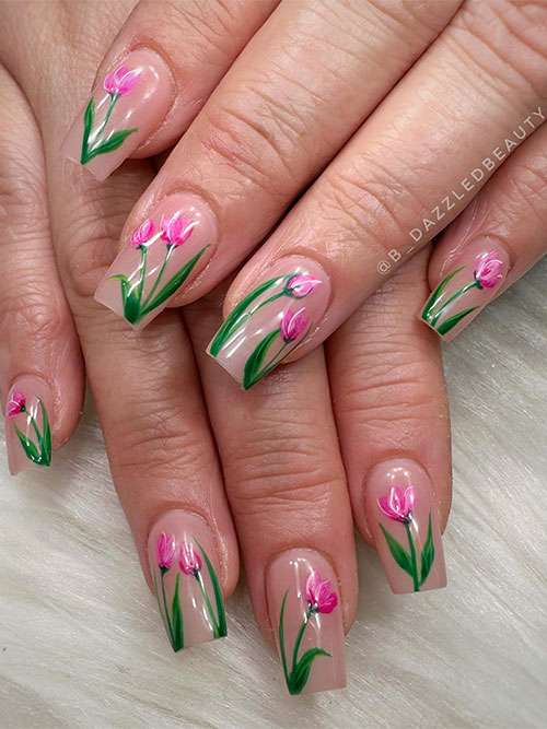 Nude coffin nails with pink flowers and green leaves are the best spring nail ideas