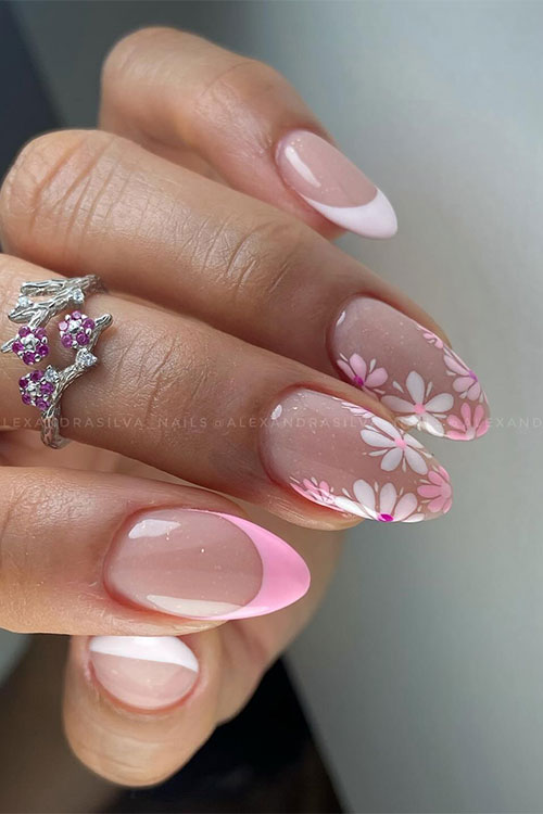 White and pink French spring nails with two accent nude nails adorned with pink and white flowers