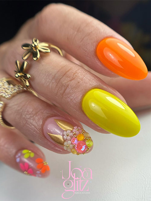 Neon yellow and orange Easter nails adorned with two accent nails adorned with flowers, rhinestones, and bunny ears