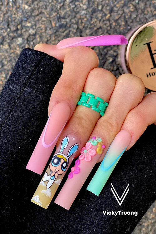 Pastel multicolored long French Easter nails with floral and bunny nail art designs on accent nails