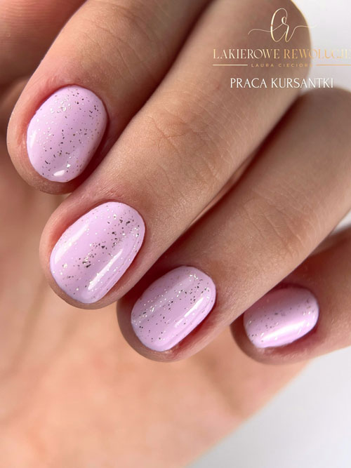 Short pastel pink spring nails with a touch of gold glitter