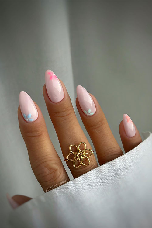 Glossy nude nails almond-shaped with multicolored delicate flowers on each nail