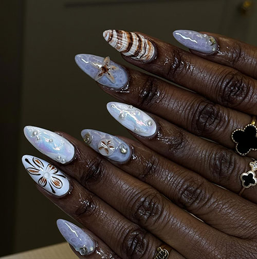 Long almond-shaped water effect nails with pearls and accent seashell nails