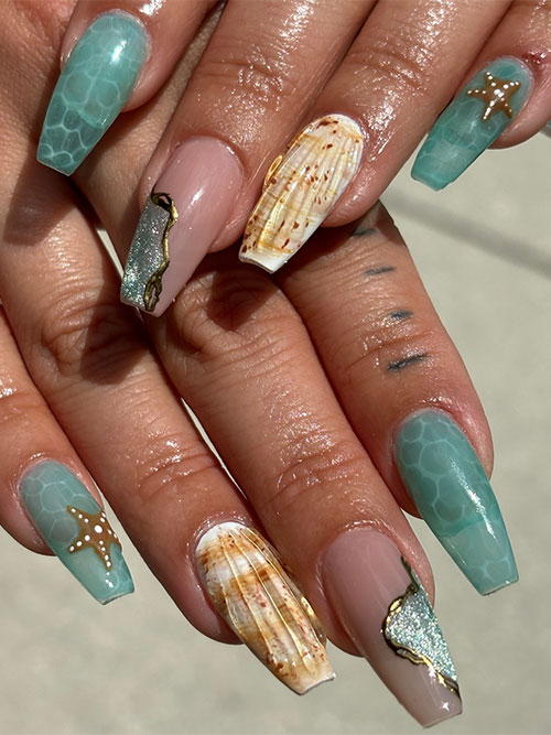 Long coffin-shaped beach nails feature water effect nail art, seashore nail art, and seashell nails
