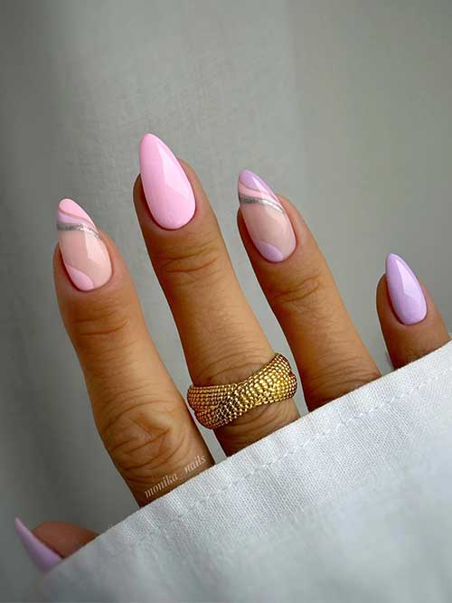 Pastel pink and lilac almond-shaped nails with two accent nails adorned with negative space nail art