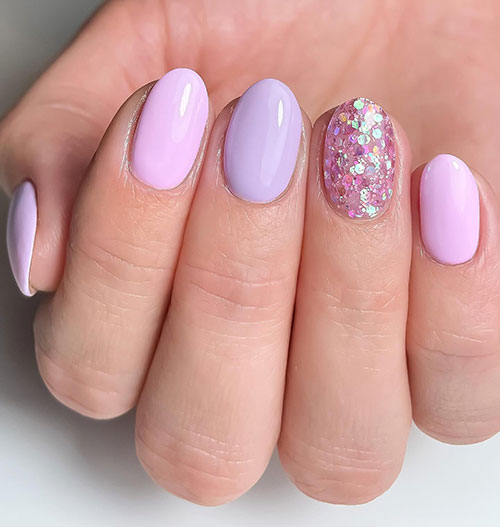 Short pink and lilac pastel nails with an accent glitter nail