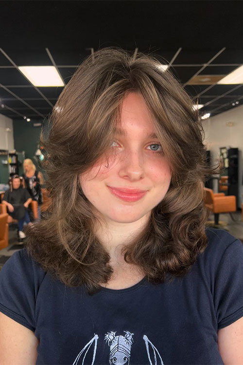 Soft medium shag haircut with curtain bangs.