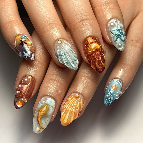  Underwater nails feature seashell nails, pearls, an octopus accent nail, and a fish accent nail