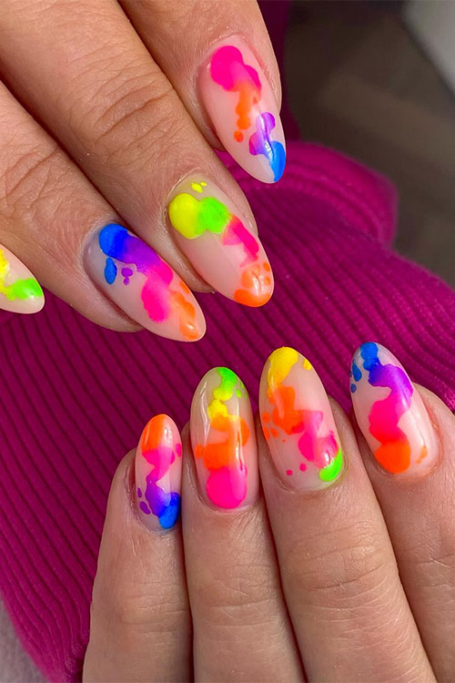 Cute almond-shaped nude nails decorated with multicolored neon abstract nail art