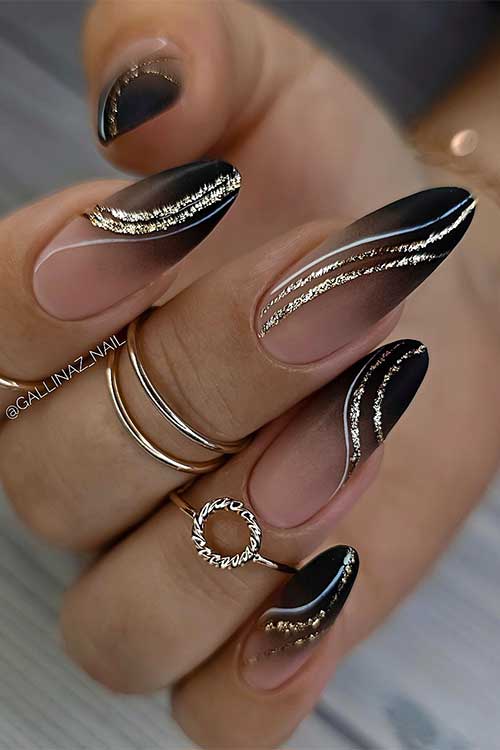 Long almond-shaped summer black ombre nails with gold glitter swirls