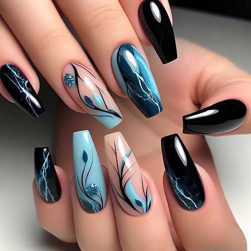 Long coffin-shaped black and sky blue nails feature marble nail art and leaf nail art on accent nails black summer nails