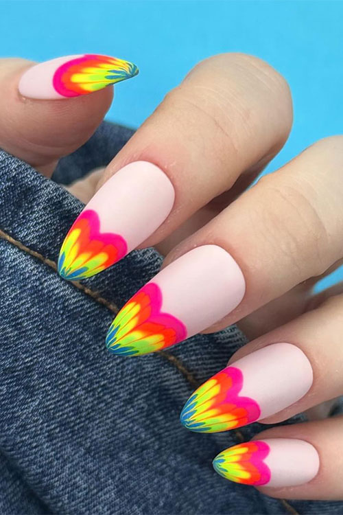 Long matte nude nails adorned with multicolored rainbow heart French tips