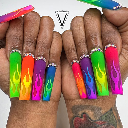 Long square-shaped matte multicolored neon nails adorned with ombre flame nail art and crystals above the cuticle