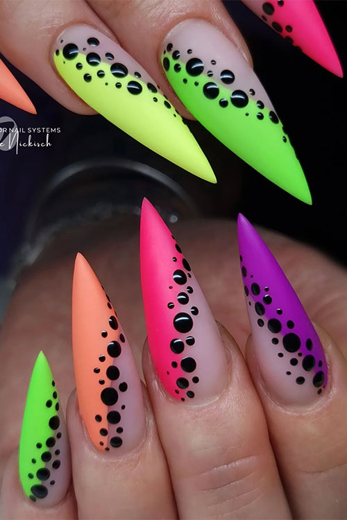 Long stiletto matte multicolored diagonal French tip nails adorned with small and big black dots