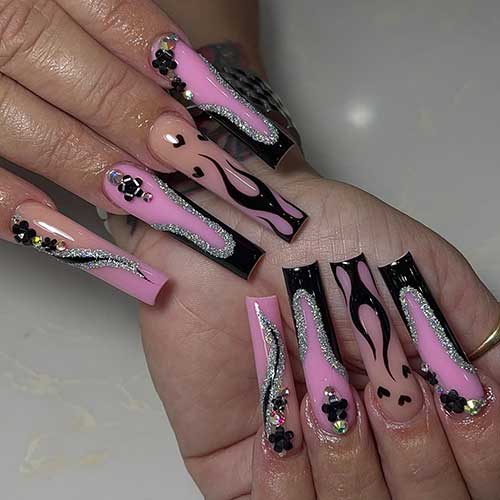 Long twisted French black summer nails over light purple base color and adorned with silver glitter and flame nail art