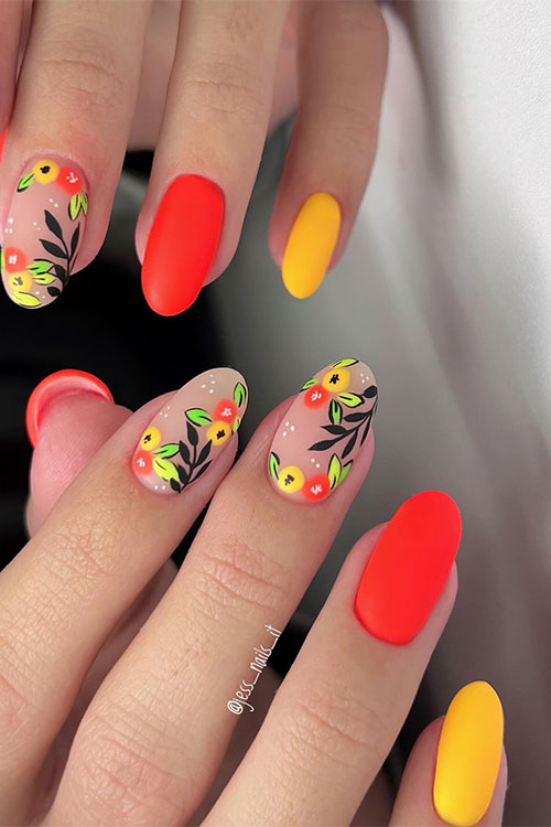 Matte orange and yellow neon nails with two accent nails adorned with orange and yellow fruits with green and black leaves