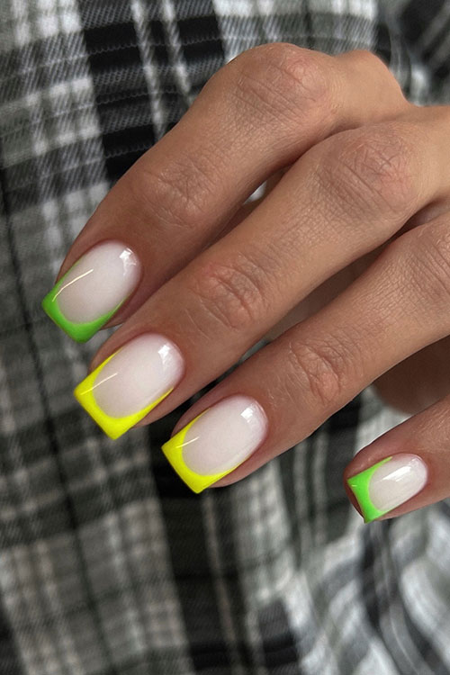 Medium square-shaped neon yellow and green French tip nails over a milky white base color