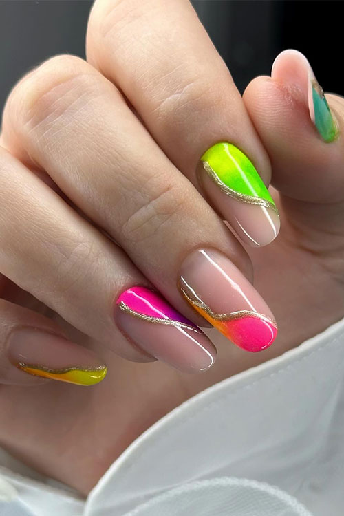 Negative space ombre multicolored neon nails over a nude base color and adorned with gold swirl nail art