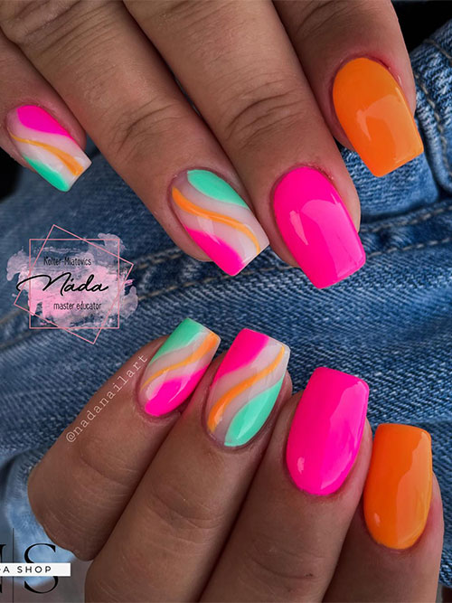 Neon summer nails feature orange and pink nails with two accents adorned with pink and mint green negative space nail art