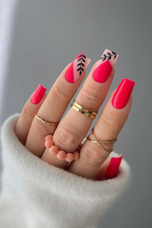 Red neon nails adorned with red geometrical nail art and black leaves on two accent nails