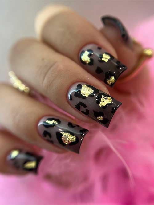 Shear black summer nails with glossy black French tips decorated with leopard animal prints and gold foil