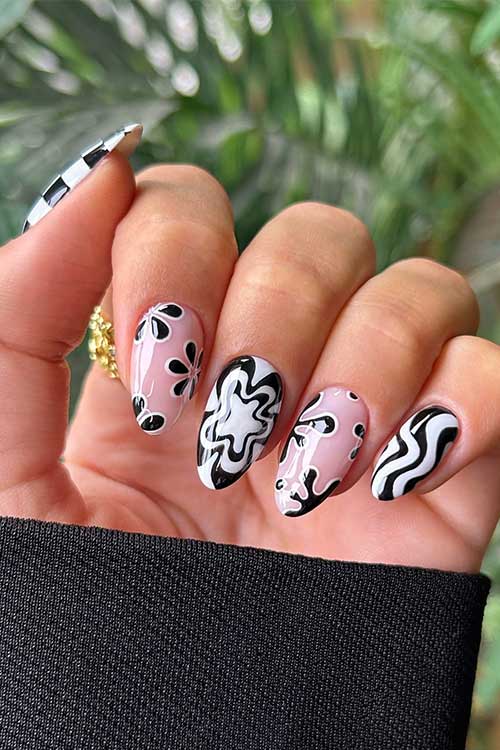 Short almond black and white mix and match nails feature checkered nail art, flowers, swirls, and abstract nail art