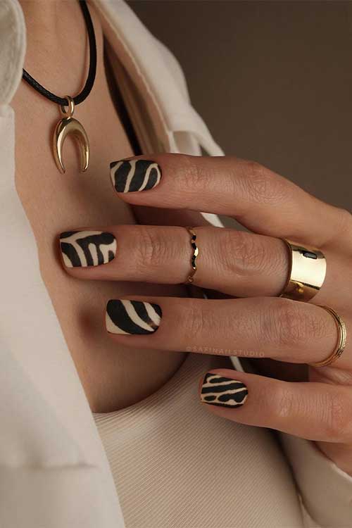 Short black matte zebra animal print nails over a white base color