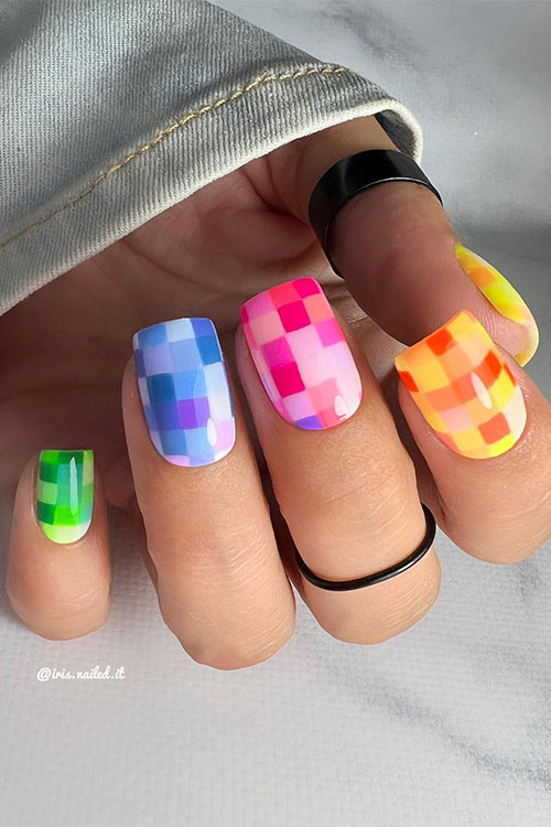 Short multicolored neon nails feature pixels for summertime