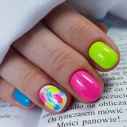 Short multicolored neon nails in yellow, pink, and blue neon nail and accent with neon abstract nail art with foil touches