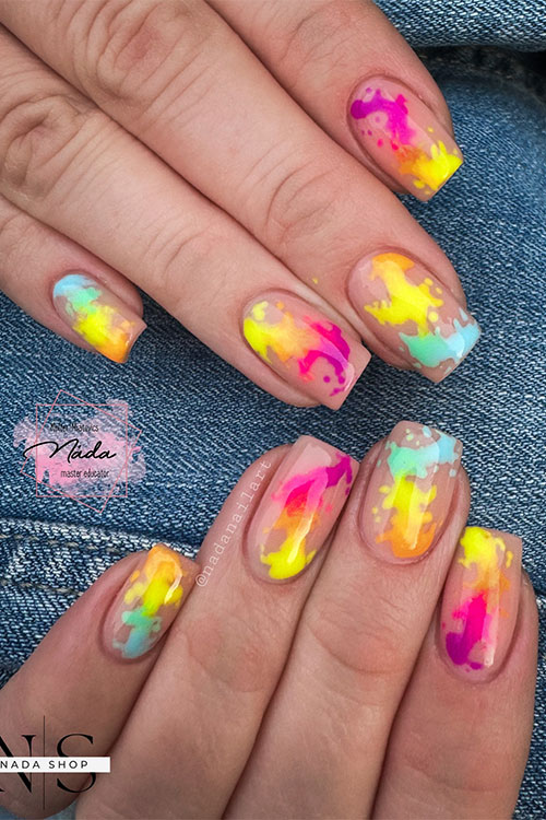 Short summer multicolored neon nails feature abstract nail art over a nude base color