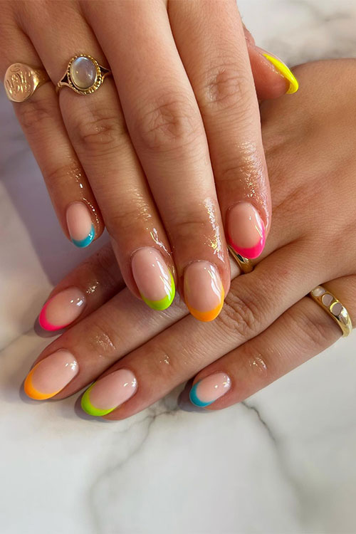 Simple short multicolored neon French tip nails in pink, yellow, blue, lime green, and orange nail colors