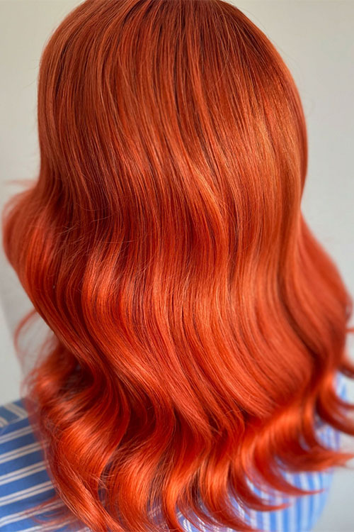 Sunset-kissed glow hair mixing a touch of orange, gold, copper, and auburn