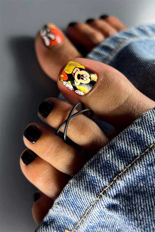 Glossy black pedicure toenails with Mickey mouse on the big toenail