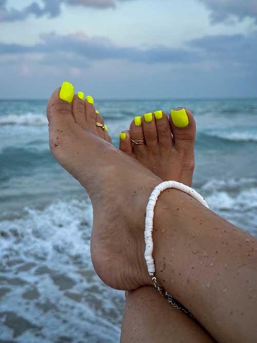 A vibrant neon yellow pedicure idea perfect for summer