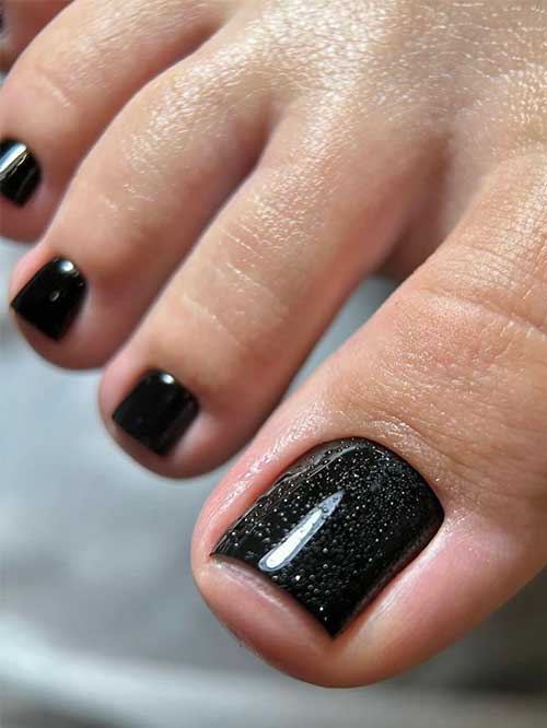 Black pedicure with glittery black big toenail