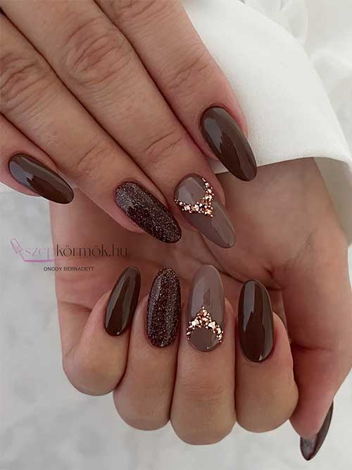 Chocolate brown nails with glitter and rhinestones on two accent nails are perfect fall nail ideas