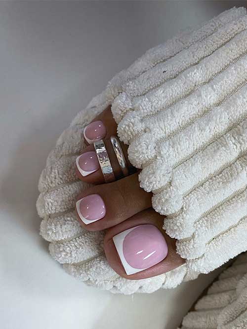 Classy French pedicure toenails over a nude pink base color.