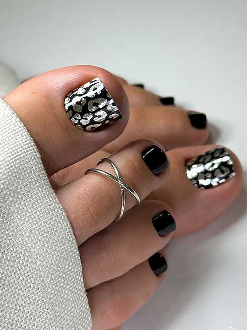 Gel black toenails with a big toenail decorated with silver leopard pedicure wrap