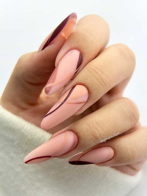 Long almond shaped matte nude nails with different brown color swirl nails