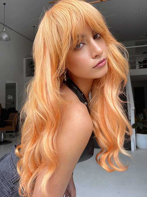 A wavy peach long shag haircut is an eye-catching choice that is perfect to make a statement.