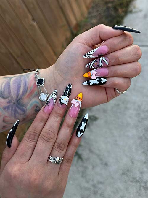 Black and white long French Halloween nails decorated with candy corn, Hello Kitty, spiders, cobwebs, and mummy nail art