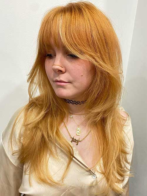 Cute copper long shag haircut for fine hair women, radiating charm and elegance with every strand.