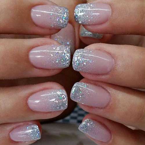 Glossy short press-on nails in a nail kit, featuring stick-on tips and glue for easy application and a polished look.