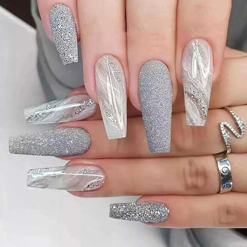 Long coffin-shaped acrylic New Year's press on nails in grey marble with glossy finish and sparkly glitter design.