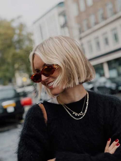 A chic short blunt bob hairstyle, characterized by its straight edges and modern look, enhancing facial features.