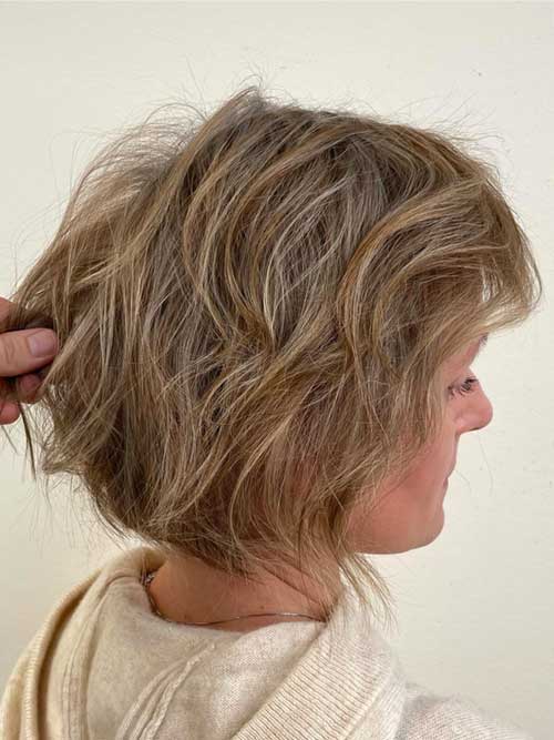 A short, messy bob haircut featuring tousled layers and a carefree, stylish appearance.