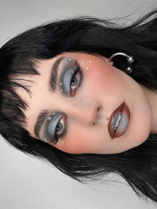 Bratty grunge makeup with vintage cream clay eyeshadows, brown lips, and smudged brown eyeliner for a bold look.