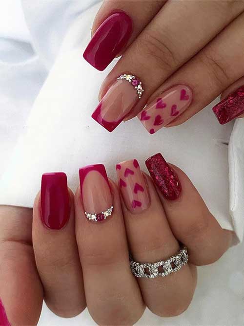 Dark red Valentine's Day press-on nails with rose pink glitter, heart designs, and rhinestones for a glossy, stylish look.