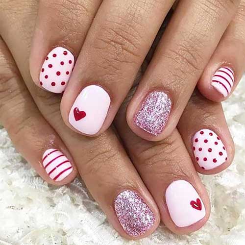 Short square pink press-on nails with a red heart glitter design, perfect for Valentine's Day